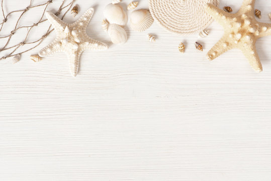 White textured wooden surface decorated with sea shells