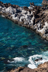 beautiful view on blue ocean water and rocky coast line