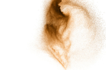 Golden sand explosion isolated on white background. Abstract sand cloud. Gold sand splash against on clear background. Sandy fly wave in the air.