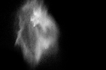 White powder explosion isolated on black background. White dust particles splash.Color Holi...