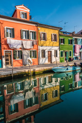 Fototapeta na wymiar Burano, an island in the Venetian Lagoon, Venice, Veneto, northern Italy. Located at the northern end of the Lagoon, known for its lace work and brightly coloured homes.