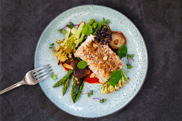 Halibut with hazelnut crust with roast red pepper sauce, asparagus, cauliflower and shiitake mushrooms