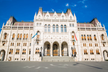 Obraz premium The entrance of Parliament in Budapest, Hungary. Bright summer day with blue sky. 
