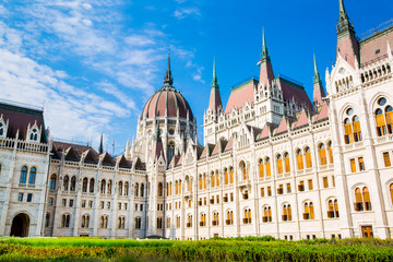Obraz premium Facade of Hungarian Parliament in Budapest and courtyard. Bright summer day. Bright blue sky in summer. 