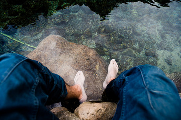 Relaxing by soaking feet in clear water