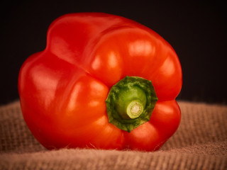 A red pepper with a rustic background