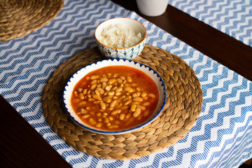 kurufasulye aka baked white beans, traditional turkish food with pilaf