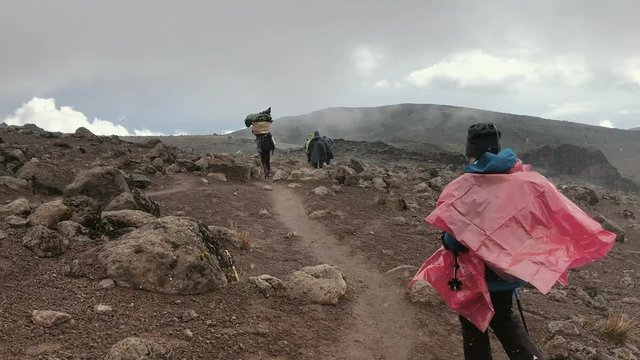 Walker under the hail during the ascent of Mount Kilimanjaro