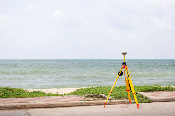 GPS surveying in field sea background, Global Positioning System.
