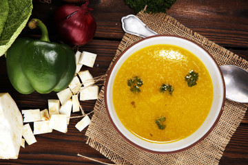 Broth with carrots, onions various fresh vegetables in a pot - colorful fresh clear spring soup. Rural kitchen scenery vegetarian bouillon or stock