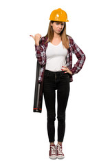 A full-length shot of a Architect woman unhappy and pointing to the side over isolated white background