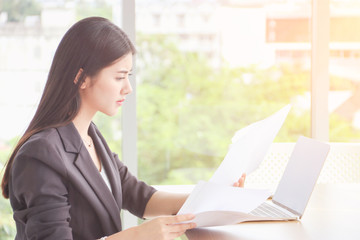 Woman are drafting a report on the computer to send to customers.