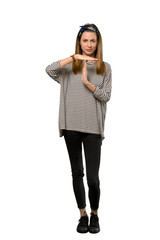 A full-length shot of a Young woman with headscarf making time out gesture over isolated white background