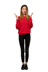 A full-length shot of a Young woman with red sweater frustrated by a bad situation over isolated white background
