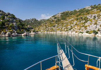 Naklejka premium Powerboat. View from the boat. Mediterranean sea overlooking the mountains. Aerial top view of sea waves hitting rocks on the beach with turquoise sea water.