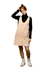 A full-length shot of a Young redhead woman having doubts while scratching head over isolated white background