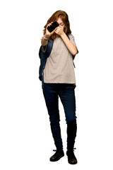 A full-length shot of a Young redhead student upset with a broken phone over isolated white background