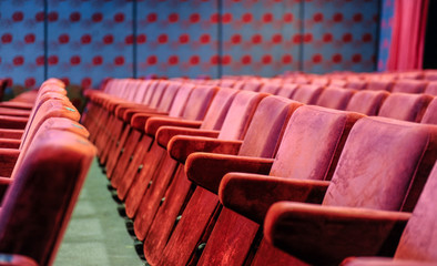 Obraz premium Cinema and music hall with comfortable red seats for audience
