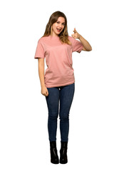 A full-length shot of a Teenager girl with pink sweater frustrated by a bad situation on isolated white background