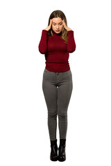 A full-length shot of a Teenager girl with turtleneck with headache over isolated white background