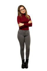 A full-length shot of a Teenager girl with turtleneck with glasses and happy over isolated white background