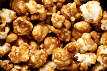 caramel pop corn background. Golden caramel popcorn close up. Background of popcorn. Snacks and food for a movie