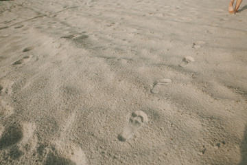 tired girl walking sand desert beach footprints