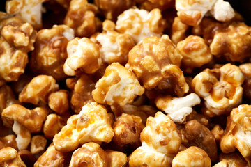 caramel pop corn background. Golden caramel popcorn close up. Background of popcorn. Snacks and food for a movie