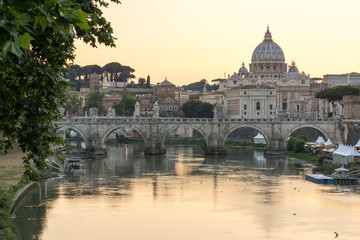 Fototapeta na wymiar Sunset Panorama of Tiber River, St. Angelo Bridge and St. Peter's Basilica in Rome, Italy