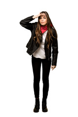 Full-length shot of Young woman with leather jacket looking far away with hand to look something on isolated white background