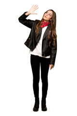 Fototapeta premium Full-length shot of Young woman with leather jacket counting five with fingers on isolated white background
