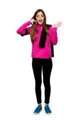 Full-length shot of Young sport woman making phone gesture and doubting over isolated white background