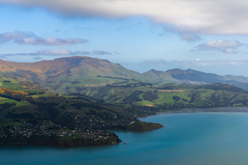 Blue water in the bay surrounded by majestic mountains