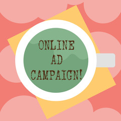 Writing note showing Online Ad Campaign. Business photo showcasing marketing effort put forward by company drive engagement Top View of Drinking Cup Filled with Beverage on Color Paper photo