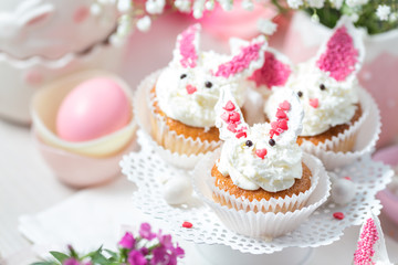 Obraz na płótnie Canvas Bunny cupcakes on a white cake stand. Easter dessert