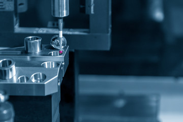 The touching probe attach on CNC machine calibration  process. The quality control on CNC milling machine.