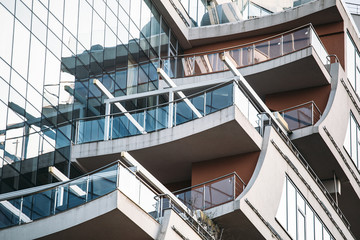 New modern high-rise building with balcony and glass