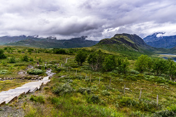 Fototapeta premium stairs up the hills in norway and dramatic sky