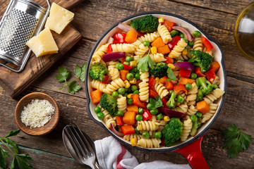 pasta with vegetables ( bell pepper, green peas, broccoli, pumpkin and corn) on pan