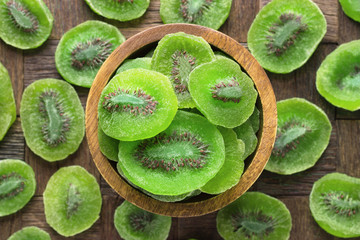 candied fruit, dried kiwi with sugar in wooden bowl, top view.