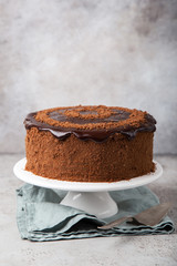 chocolate honey cake on white cake stand,