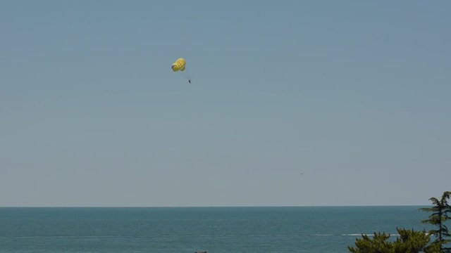 Parachuting in nice parasailing with a boat over sea in nice in a beautiful summer day