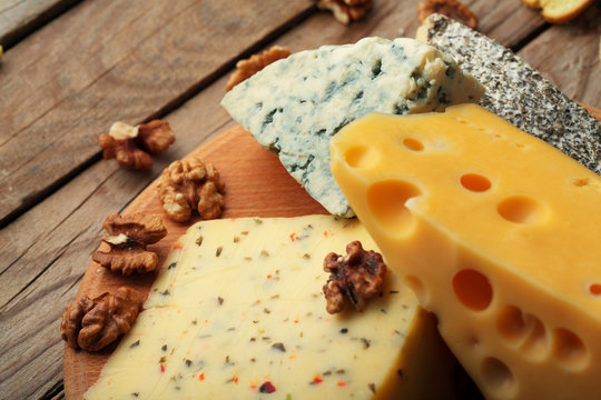 Various types of cheese on wooden board.Copy space.Chessnut.
