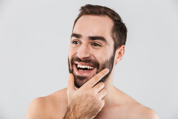 Close up of a young handsome bearded shirtless man