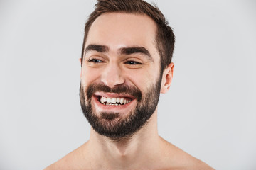Close up of a young handsome bearded shirtless man