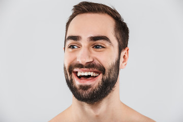 Close up of a young handsome bearded shirtless man