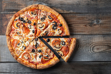 Tasty pepperoni pizza with mushrooms and olives.