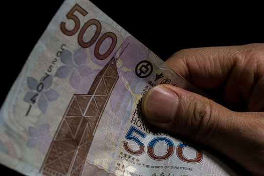 Holding banknotes of Hongkong dollars (HKD) 