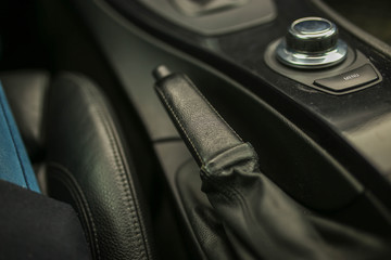 handbrake lever in a car with leather upholstery