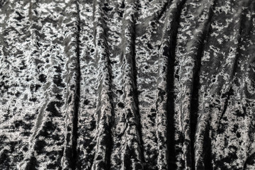 Obraz premium Grey, pinkish, purple velvet background. Soft textile fabric, pleasant to the touch. Delicate material, crumpled and collected in different directions. In the light with shadows. Pronounced texture.